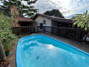 Casa com piscina duas quadras da Praia da Ferrugem 100